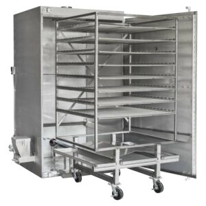 Angled view of a Rocket Outdoors roll-in gas smoker with door open, showing the wheeled rolling rack cart loaded into the cooking chamber.